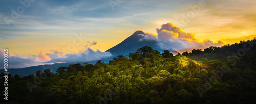 Arenal Volcano at Sunrise...A rare sight at the perfect 15 second window to capture sunrise in all of it's glory. Light glistens off the clouds and the mountain and the jungle.