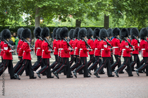 Queen's foot guards marching in formation down The Mall in a royal Trooping the Colour ceremony in London England