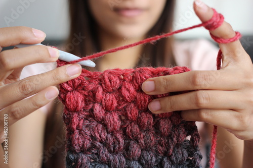 A girl showing how to crochet