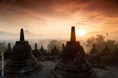 Silhouette of Ancient stupa Borobudur Temple, with sunrise in Yo