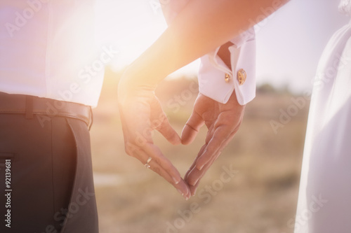 Bride and groom holding his hands