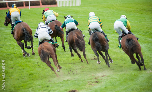 race horses taking a sharp turn on the race track