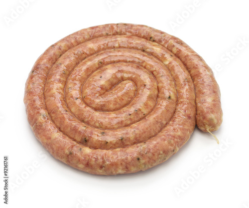 raw cumberland sausage, spiral pork sausage isolated on white background