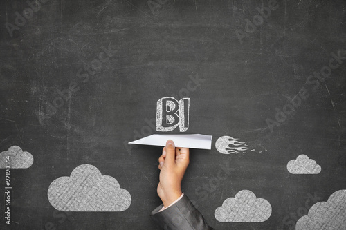 BI concept on blackboard with paper plane