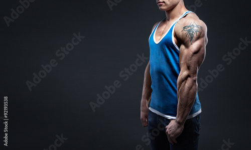 strong man in jeans shows triceps