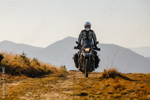 Motorbiker travelling in autumn mountains