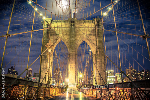 Beautiful Brooklyn Bridge in New York City seen at night from the pedestrian walkway