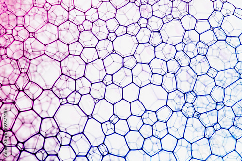 Geometric shapes background of soap bubbles with blue and purple ink.