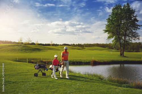 Father with son at golf field