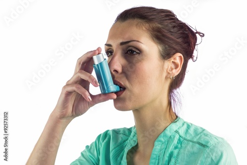 Close-up of woman using asthma inhaler 