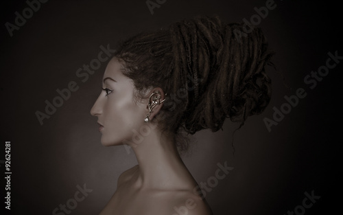 Nefertiti, stylized fashion shoot. Woman with a dreadlocks bun