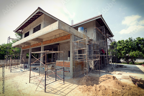 building residential construction house with scaffold steel