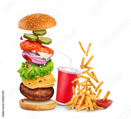 Flying ingredients of hamburger, fried potatoes, ketchup and pap