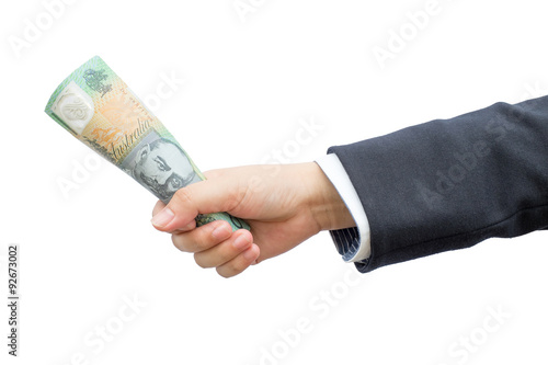 Businessman hand holding roll Australian dollars (AUD) on isolated background.