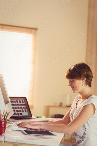 Casual businesswoman using her computer