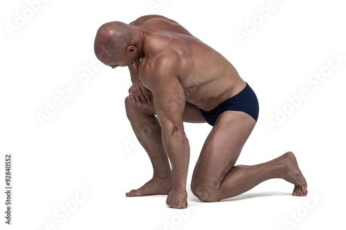 Athlete exercising while kneeling down