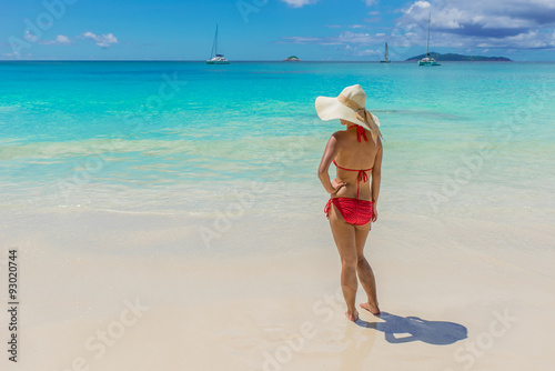 Girl with sunhat at Paradise beach 