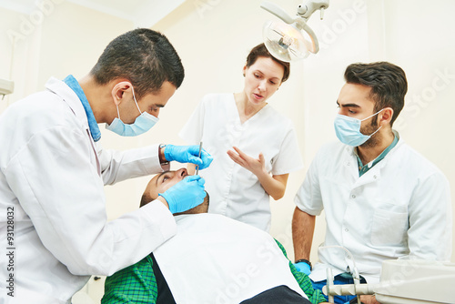 Female dentist doctor teaching students