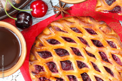 Coffee and sweet pie with cherry and spices