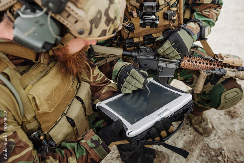 commander of the soldiers paves the route on an electronic table