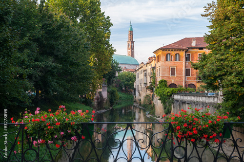 View of Retrone river and the clock tower of Vicenza, Italy, seen from Furo bridge