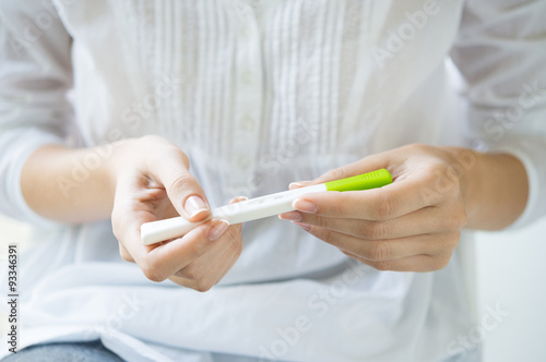 Woman holding pregnancy test