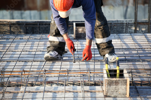 workers make reinforcement for concrete foundation