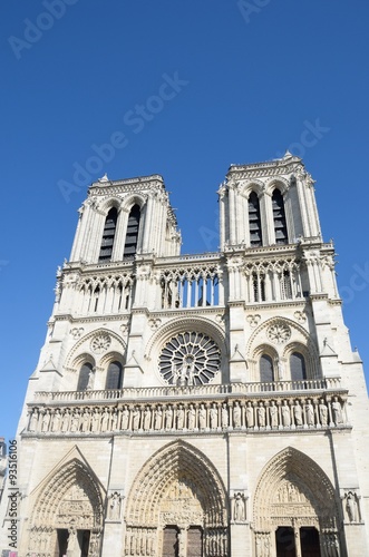 Front of Notre Dame Cathedral with bright blue sky in background