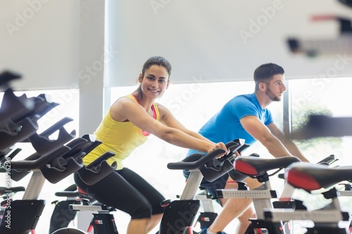 Couple using exercise bikes together