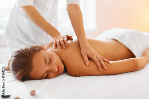 Spa treatment. Woman enjoying massage in spa centre.