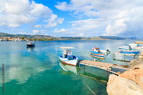Greek fishing boats on turquoise sea water mooring in port, Samos island, Greece