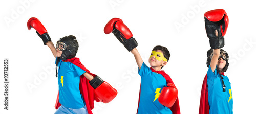 Child dressed like superhero with boxing gloves