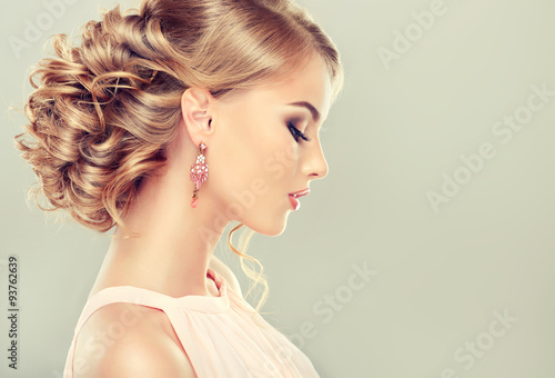 Beautiful model with elegant hairstyle . Beautiful woman with fashion wedding hairstyle and colourful makeup 