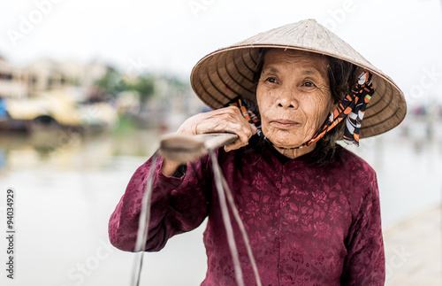 Old friendly woman with vietnamese straw hat