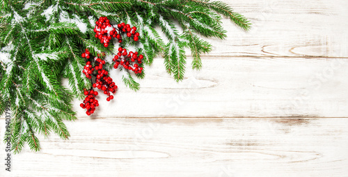 Christmas decoration border. Fir tree branch with red berries