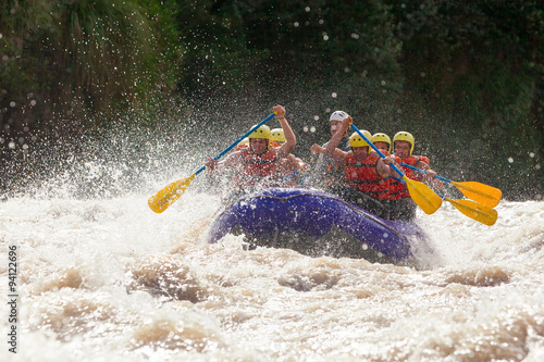 A team of extreme sports enthusiasts enjoying the thrill of whitewater rafting in Ecuador's rapids, showcasing teamwork and outdoor fun.