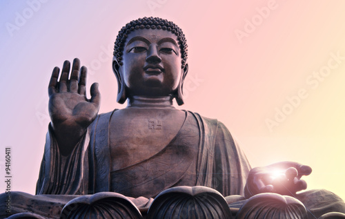 Buddha statue at Po Lin, Hong Kong. Bright light from hand.