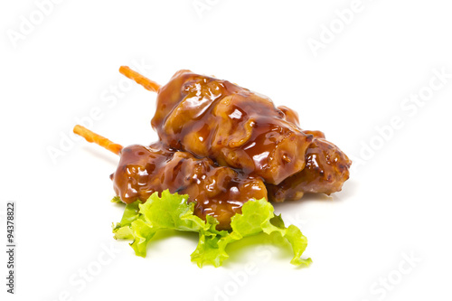 Chicken teriyaki with skewers isolated on white.