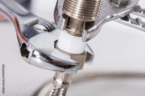 Plumber screwing plumbing fittings