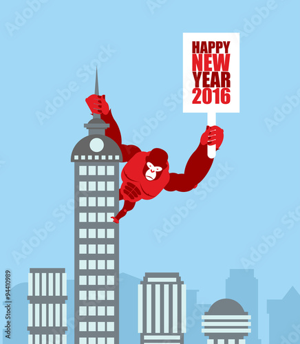Monkey on skyscraper. King Kong holds a sign with new year. Huge