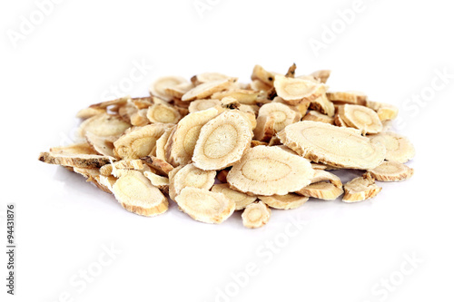 Chinese Herbal medicine - Astragalus slices, Huang Qi (Astragalus propinquus) on white background (manual focus) 