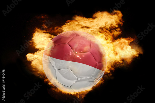 football ball with the flag of indonesia on fire