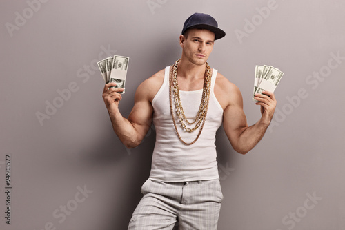 Young male rapper holding money