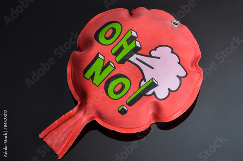 red whoopee cushion with reflection on black glass