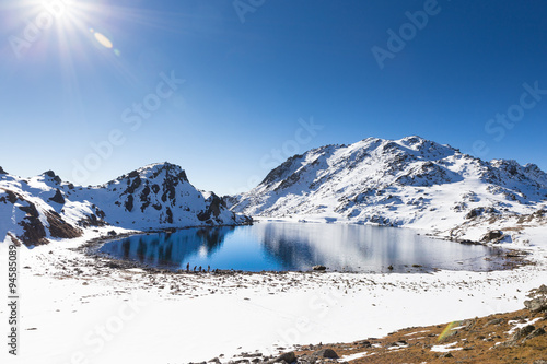 Blue lake mountains covered snow, Gosaikunda Nepal.