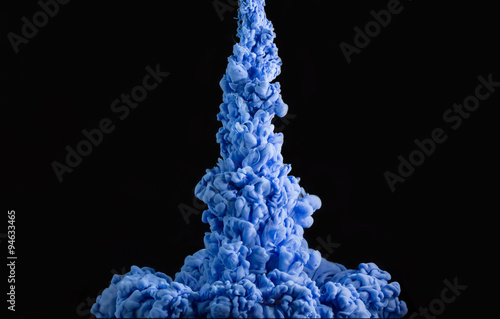 Blue ink in water as a smoke on a black background.