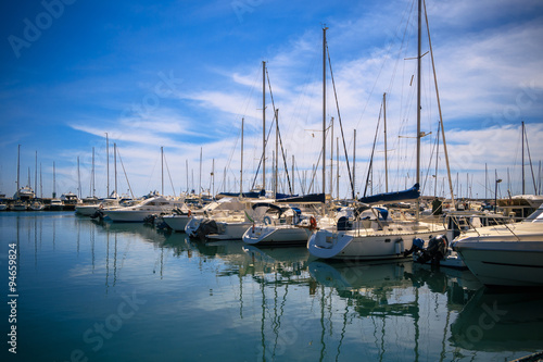 Stock Photo beauty Harbor Yacht Club with glazed clear sea and blue clouds