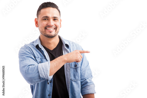 Handsome man pointing to copy space