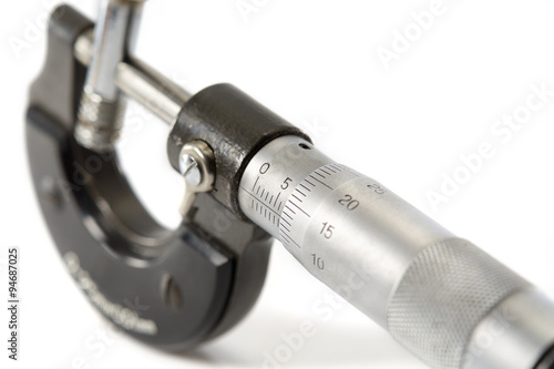 Micrometer/Used and dirty micrometer, device used to tiny measurements on white background. select focus on numberic.