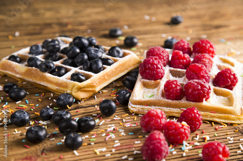 Waffles with whipped cream and raspberries and cranberries 